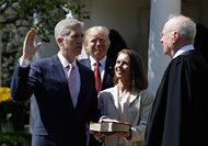 President Donald Trump watches as Supreme Court Justice Anthony M. Kennedy administers the judicial oath to Judge Neil Gorsuch during a re-enactment in the Rose Garden of the White House White House in Washington, D.C., today. Holding the Bible is Gorsuch’s wife Marie Louise Gorsuch. 