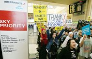 Demonstrators opposed to President Donald Trump’s executive order barring travelers and immigrants from seven predominantly Muslim countries from entering the U.S. march through Tom Bradley International Terminal at Los Angeles International Airport on Saturday. One sign thanks federal judge James L. Robart, who issued a stay of the order. 