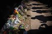 Visitors cast shadows at a memorial to the victims of the Astroworld concert in Houston in 2021.  AP Photo/Robert Bumsted, File