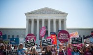 Pro-choice and pro-life demonstrators rally outside of the U.S. Supreme Court on Monday morning. The court is expected to hand down its decision on a Texas law which requires clinics to meet the same standards as ambulatory surgical centers and forces doctors to have admitting privileges at nearby hospitals next week. 