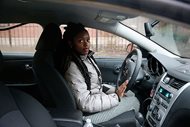 In this April 5, 2017. photo, Kara Bland sits in her car in Chicago. Bland was a victim of a contentious practice that allows law enforcement to seize vehicles, cash and other property thought to be connected to a crime, and to profit from it. The plight of innocents whose property is seized has helped fuel a flurry of legal changes throughout the country that seek to limit such police powers. 