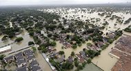 A neighborhood near Addicks Reservoir in Houston is flooded by Hurricane Harvey in this aerial shot taken Tuesday. Houston’s population is growing quickly, but when Harvey hit last weekend there were far fewer homes and other properties in the area with flood insurance than just five years ago, according to an Associated Press investigation. 