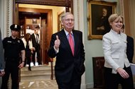 Senate Majority Leader Mitch McConnell of Kentucky signals a thumbs-up as he leaves the Senate chamber on Capitol Hill in Washington, D.C., today, after he led the GOP majority to change Senate rules and lower the vote threshold for Supreme Court nominees from 60 votes to a simple majority in order to advance Neil Gorsuch to a confirmation vote. 