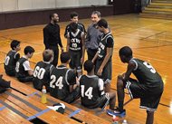 Chapman, Spingola partner Robert A. Chapman huddles with basketball players from Frances Xavier Warde School during practice. He’s coached seventh- and eighth-grade boys’ teams at the West Loop Catholic school for the past 10 years. 