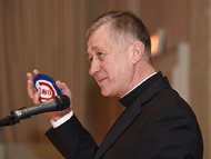 Archbishop Blase Cupich holds a Cubs-themed yarmulke given to him by Rabbi Steven Stark Lowenstein at a Chicago Bar Association luncheon on Thursday. Cupich, who will formally become a cardinal next month in Rome, joked that he may show the Jewish skullcap to the pope when they meet. 